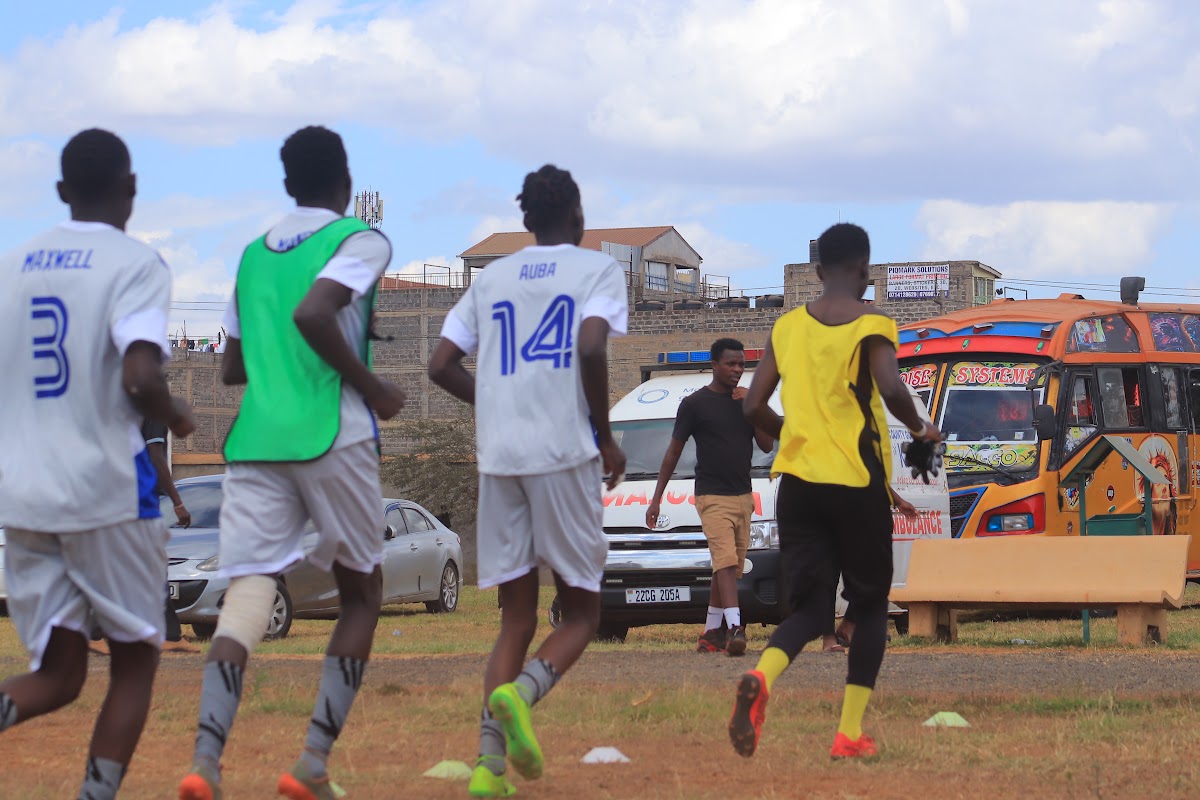 Players in white and yellow kits competing on the football pitch